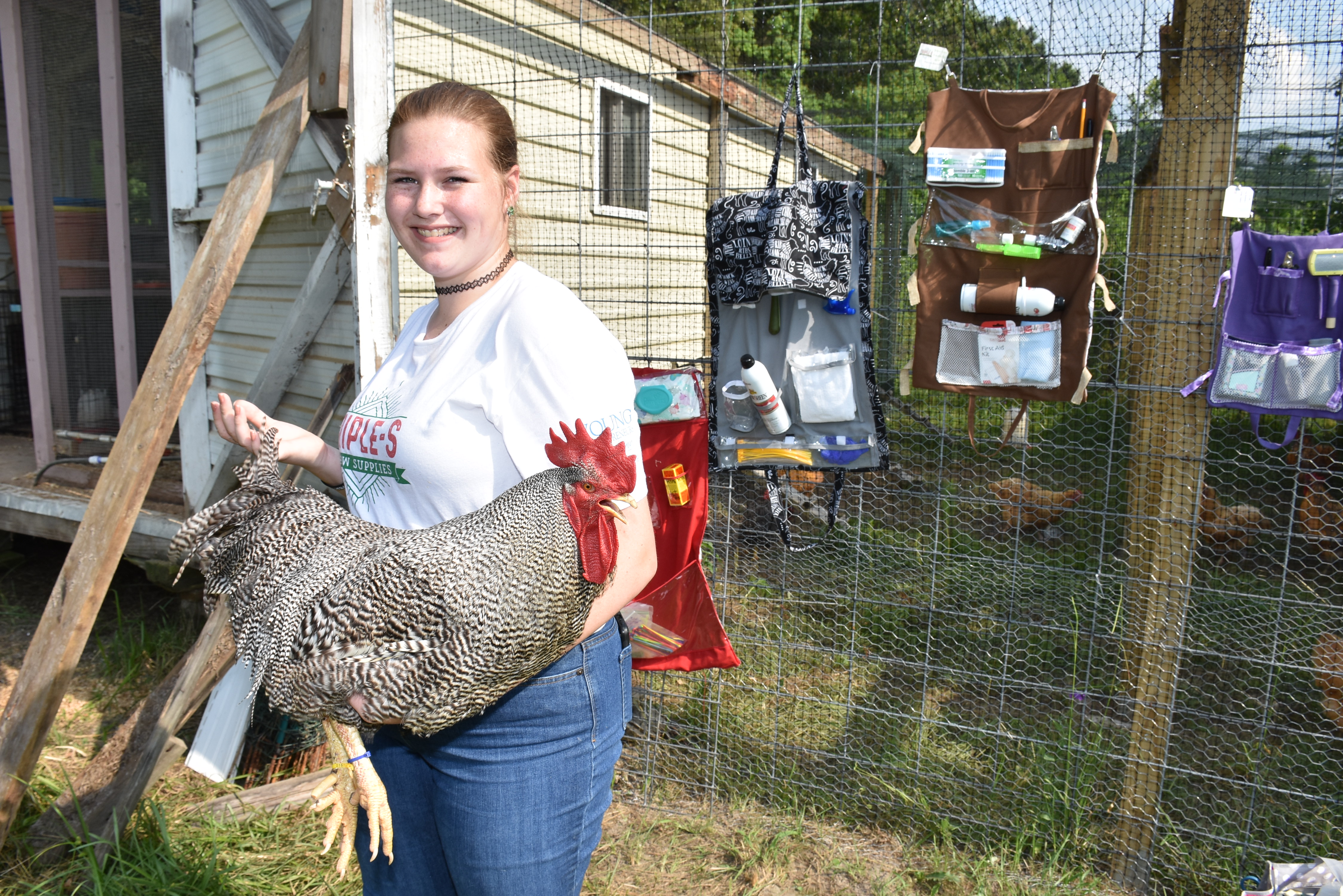 Sarah Irael holds one of her prized roosters.